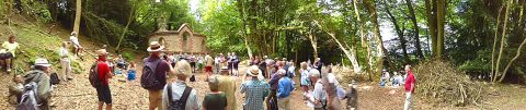 A panorama of local people, are seen enjoying a small choir at a derelict but beautiful chapel old chapel.